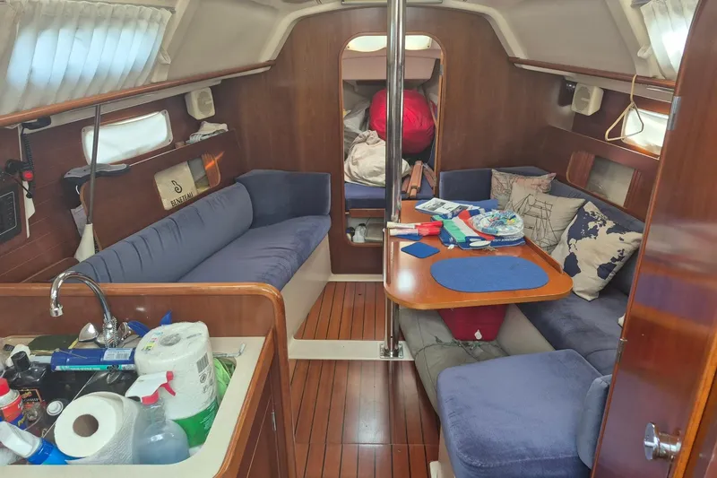 Slide: The Image of Interior of a 1997 Beneteau Oceanis 321 sailboat with cozy seating and wooden finishes. - 10
