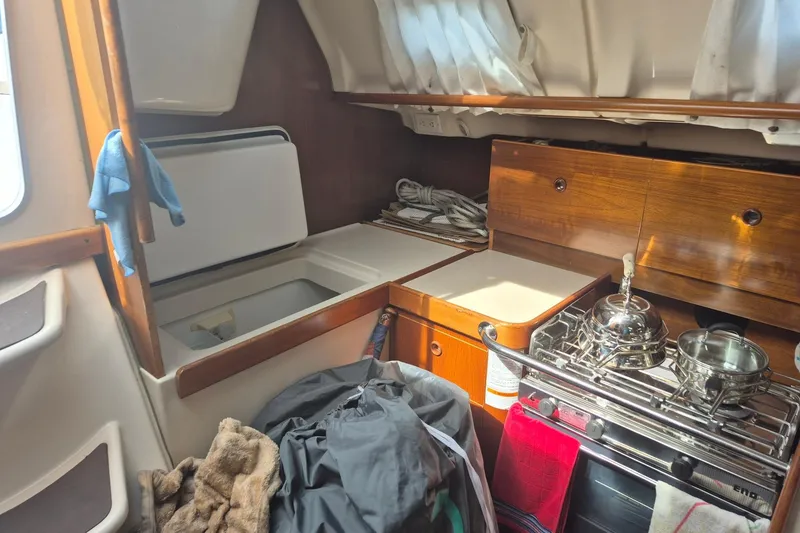 Slide: The Image of Interior of a 1997 Beneteau Oceanis 321 sailboat kitchen with stove and storage. - 11
