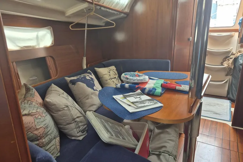 Slide: The Image of Interior of 1997 Beneteau Oceanis 321 sailboat with cozy seating and nautical decor. - 12