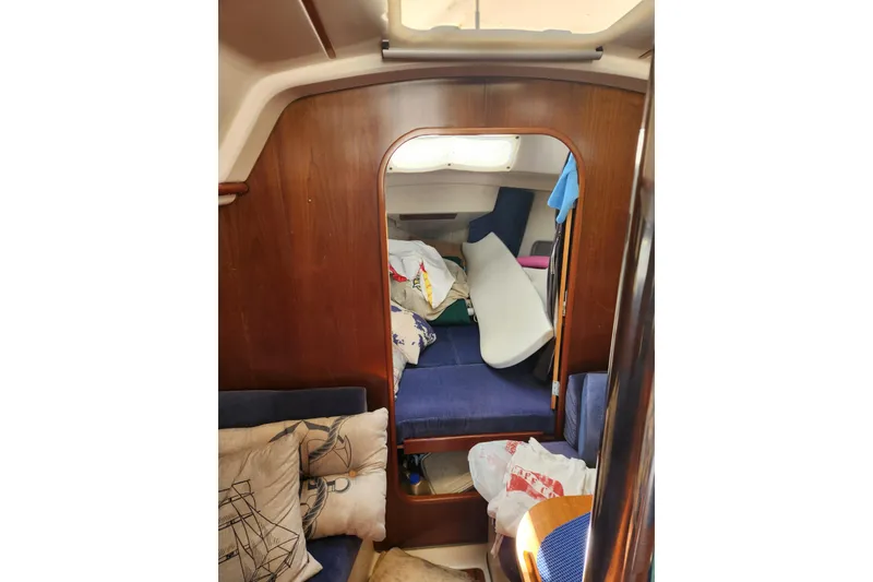 Slide: The Image of Interior of 1997 Beneteau Oceanis 321 sailboat with wooden paneling and blue seating. - 14