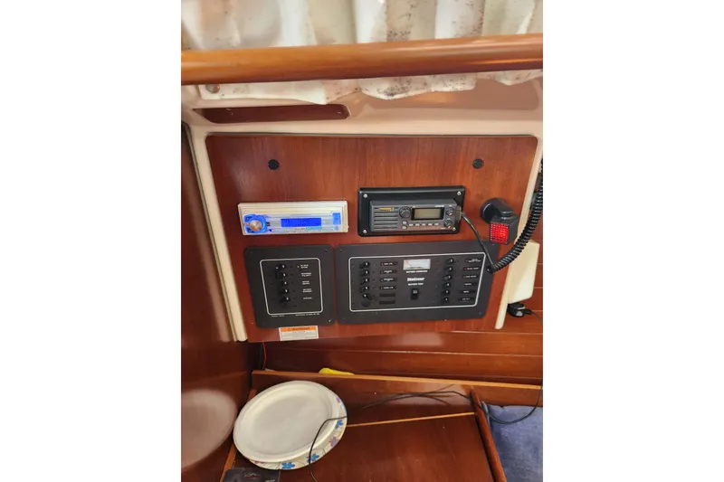 Slide: The Image of Control panel of a 1997 Beneteau Oceanis 321 sailboat with radio and switches. - 16