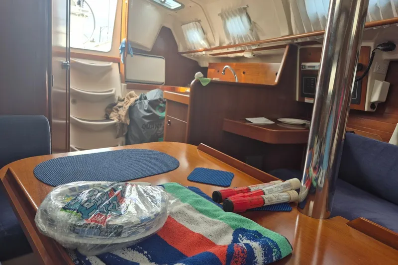Slide: The Image of Interior of a 1997 Beneteau Oceanis 321 sailboat with dining area and kitchen. - 17