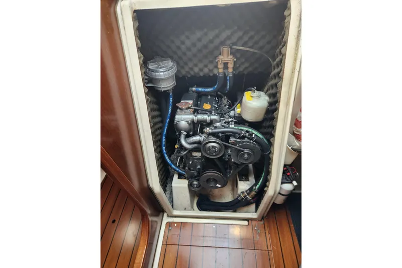 Slide: The Image of Engine compartment of a 1997 Beneteau Oceanis 321 sailboat, showcasing mechanical components. - 26