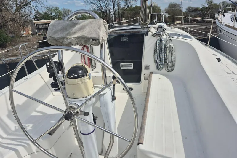 Slide: The Image of Cockpit of 1997 Beneteau Oceanis 321 sailboat with steering wheel and navigation instruments. - 8