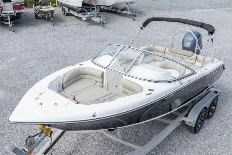 Slide: The Image of 2022 Key West 203 DFS boat on trailer, featuring sleek design and spacious seating. - 11
