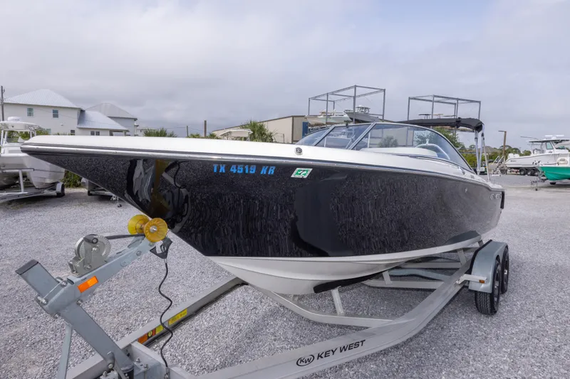 Slide: The Image of 2022 Key West 203 DFS boat on trailer in a marina setting. - 17