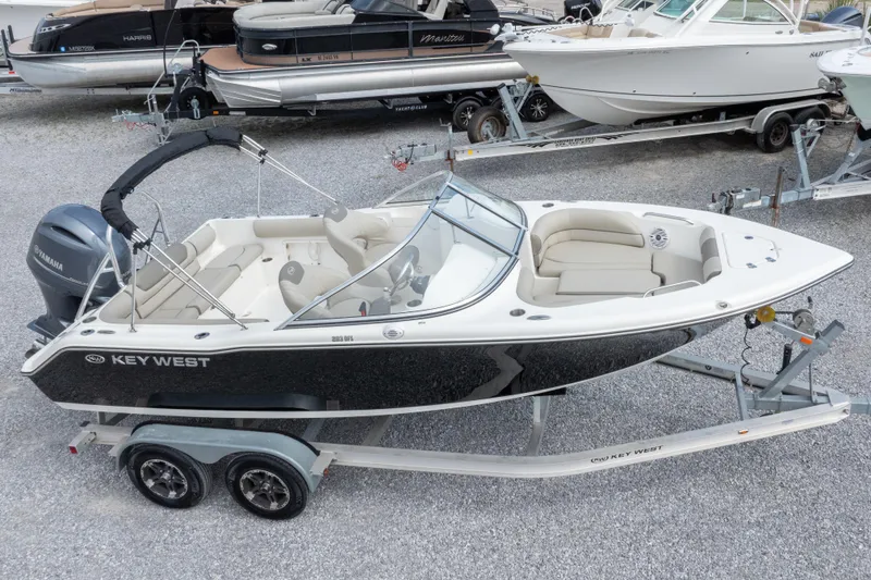 Slide: The Image of 2022 Key West 203 DFS boat on trailer, featuring sleek design and Yamaha engine. - 2