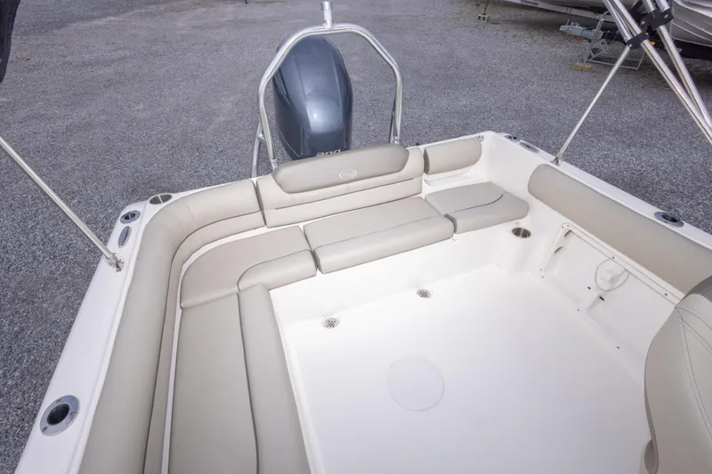 Slide: The Image of 2022 Key West 203 DFS boat interior with cushioned seating and outboard motor. - 23
