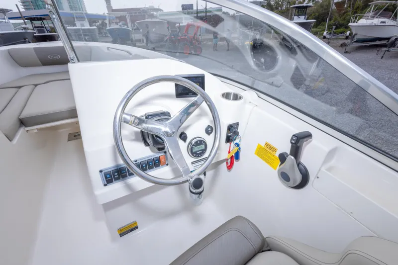 Slide: The Image of 2022 Key West 203 DFS boat dashboard with steering wheel and controls. - 27