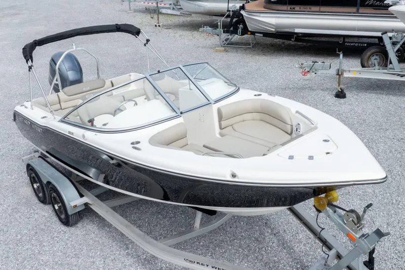 Slide: The Image of 2022 Key West 203 DFS boat on trailer, featuring sleek design and spacious seating. - 3