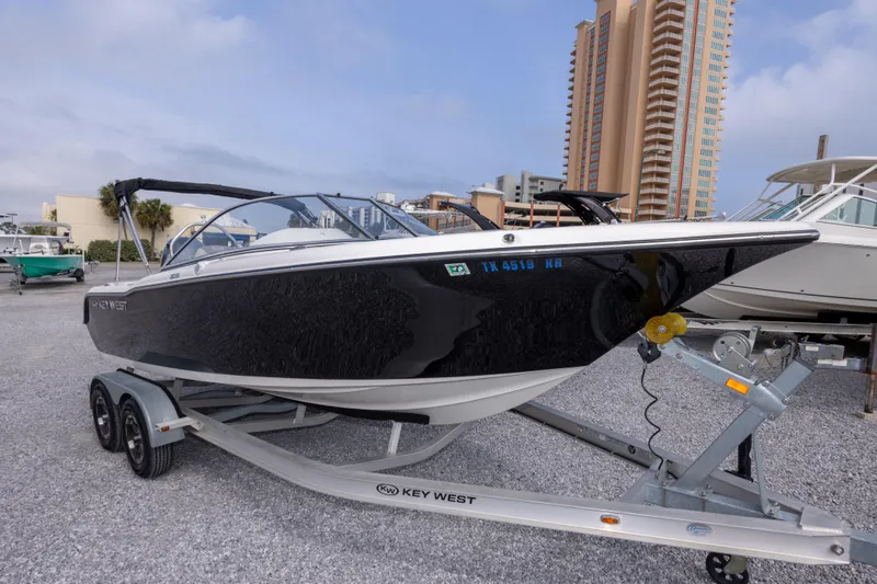 Slide: The Image of 2022 Key West 203 DFS boat on trailer, parked near tall buildings. - 37