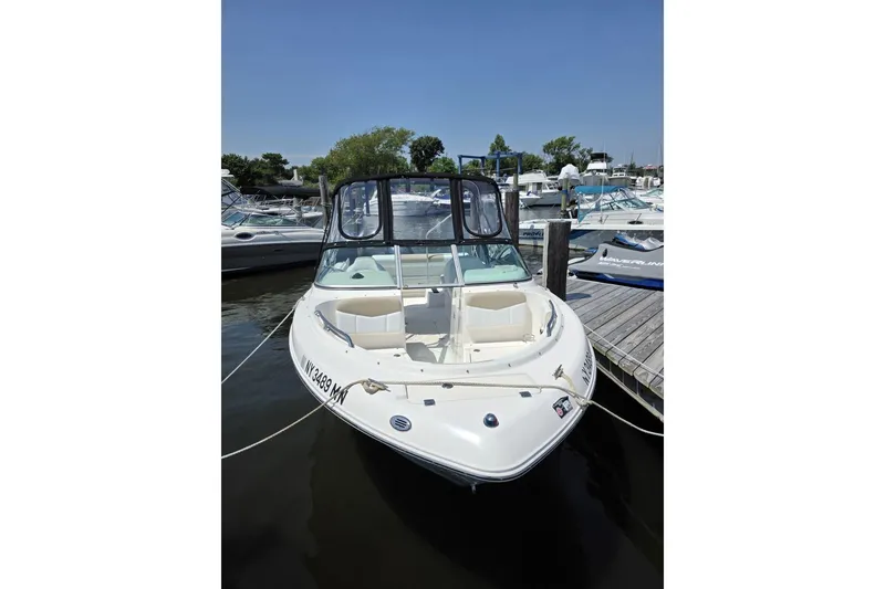 Slide: The Image of 2018 Robalo R227 Dual Console boat docked at marina, sunny day. - 3