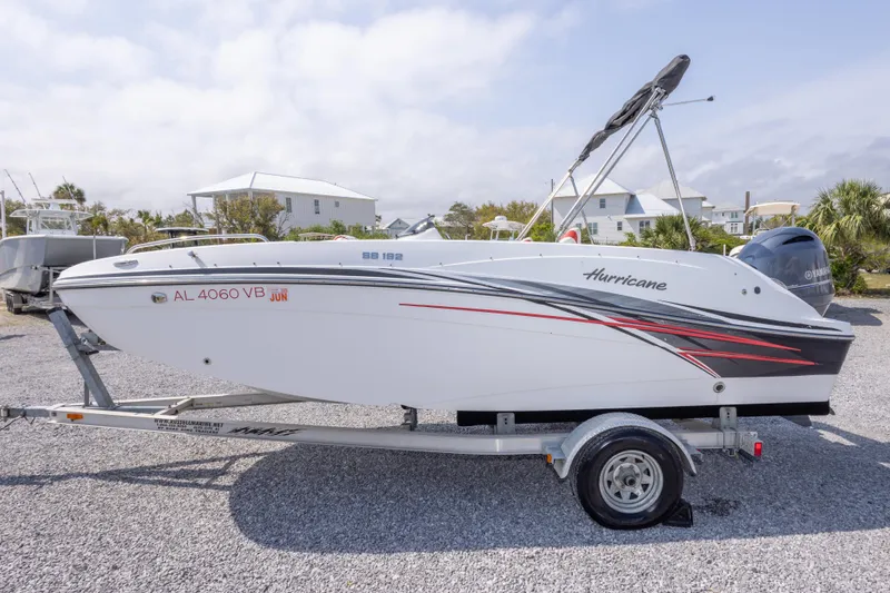 Slide: The Image of 2018 Hurricane SunDeck Sport 192 OB boat on trailer, side view, outdoors. - 12
