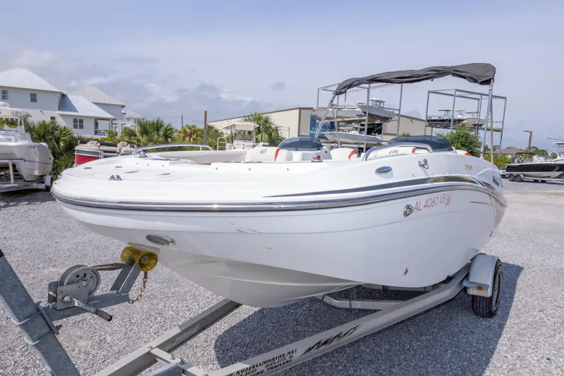 Slide: The Image of 2018 Hurricane SunDeck Sport 192 OB boat on trailer in marina setting. - 13