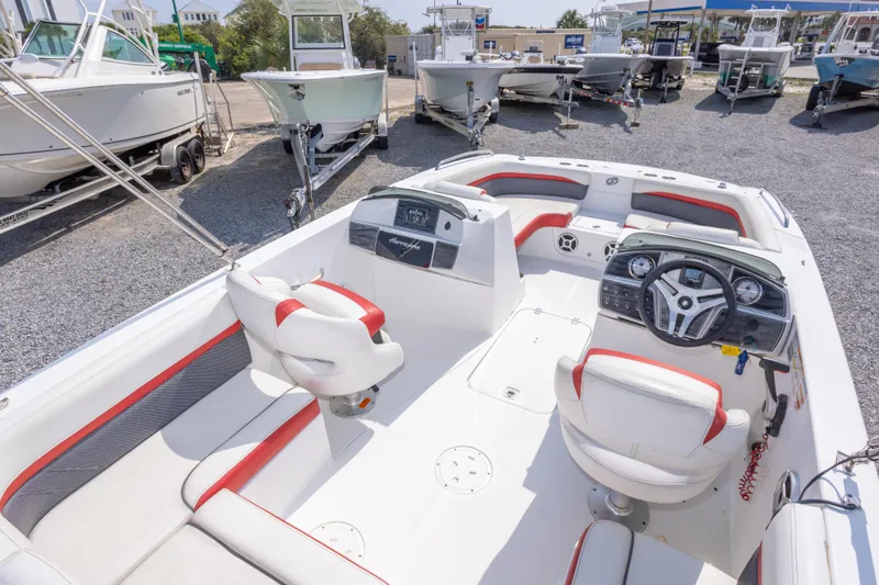 Slide: The Image of 2018 Hurricane SunDeck Sport 192 OB boat interior with red and white seating, steering console. - 15