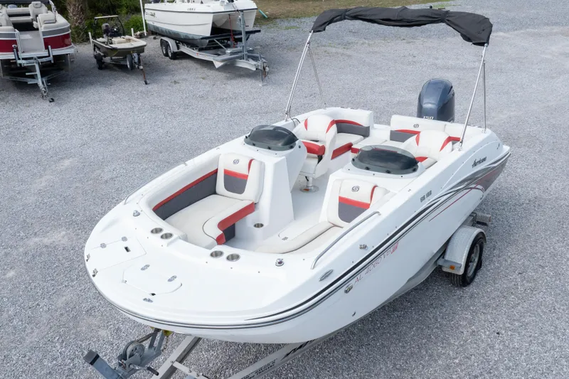 Slide: The Image of 2018 Hurricane SunDeck Sport 192 OB boat on trailer, featuring spacious seating and sleek design. - 2