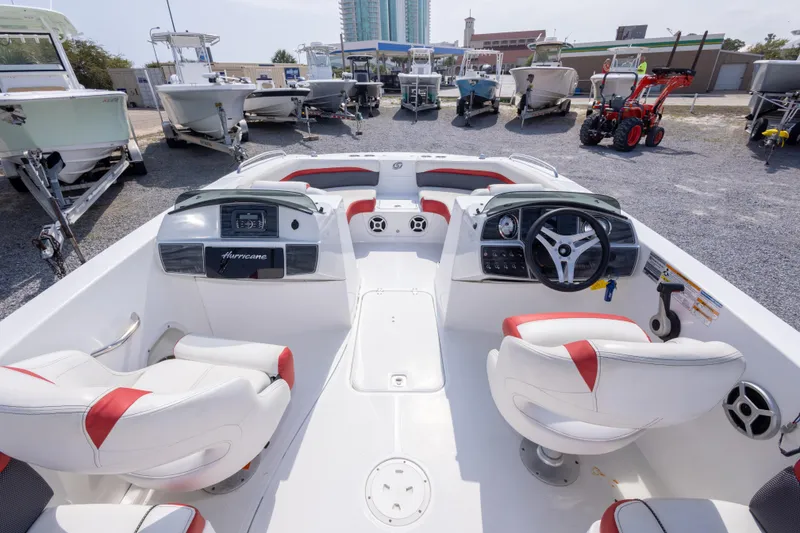 Slide: The Image of 2018 Hurricane SunDeck Sport 192 OB boat interior with steering wheel and seating, displayed outdoors. - 21