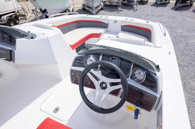 Slide: The Image of 2018 Hurricane SunDeck Sport 192 OB boat interior with steering wheel and seating. - 24