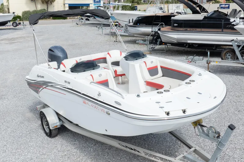Slide: The Image of 2018 Hurricane SunDeck Sport 192 OB boat on trailer, featuring sleek design and spacious seating. - 28