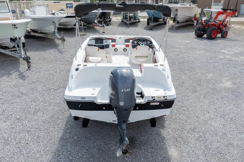 Slide: The Image of 2018 Hurricane SunDeck Sport 192 OB boat with Yamaha outboard motor, parked on gravel. - 31