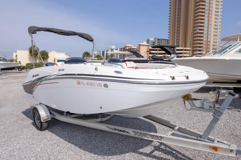 Slide: The Image of 2018 Hurricane SunDeck Sport 192 OB boat on trailer, parked outdoors. - 4