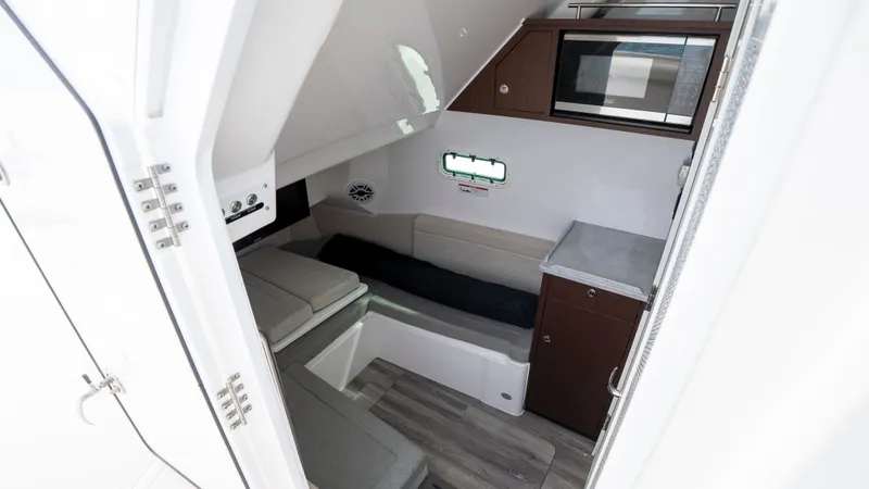 Slide: The Image of Interior of 2022 Everglades 395 Center Console with seating and microwave. - 15