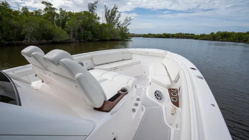 Slide: The Image of Everglades 395 Center Console 2022 on calm river with lush shoreline. - 19