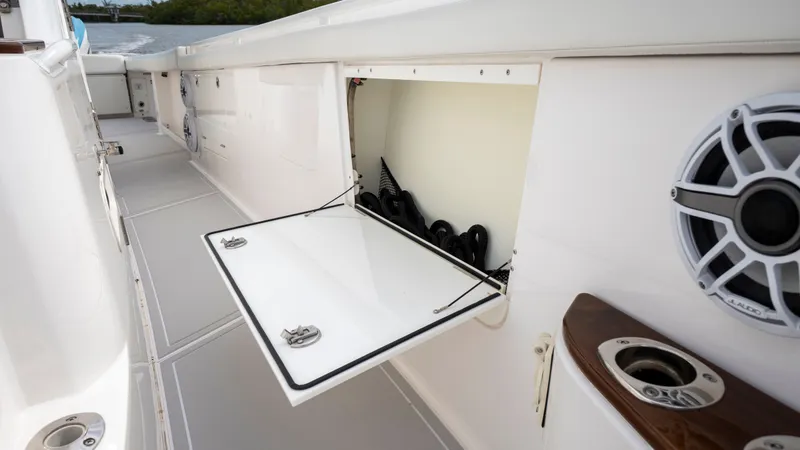 Slide: The Image of Everglades 395 Center Console 2022 with open storage compartment and speaker. - 38
