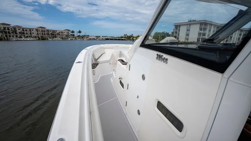 Slide: The Image of Everglades 395 Center Console 2022 on calm water near buildings. - 45