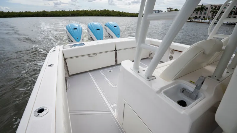 Slide: The Image of Everglades 395 Center Console 2022 with triple outboard engines on the water. - 47
