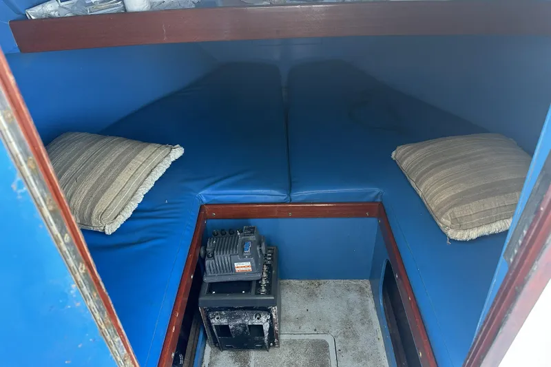 Slide: The Image of Interior of a 1990 Seaway 31 boat with blue cushions. - 12