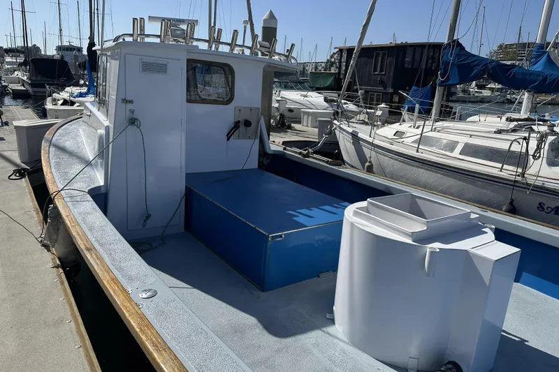Slide: The Image of 1990 Seeway 31 boat docked at marina, surrounded by other sailboats under clear blue sky. - 6