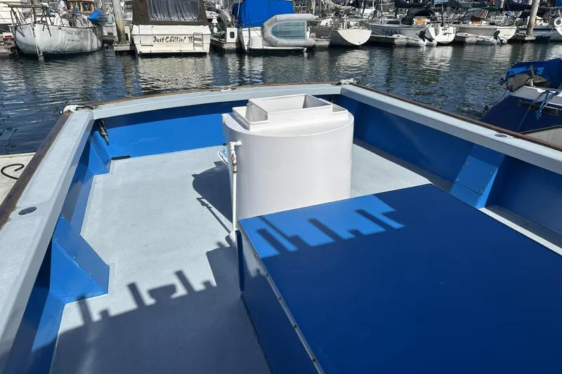 Slide: The Image of Open deck of a 1990 Seeway 31 boat docked at a marina. - 7