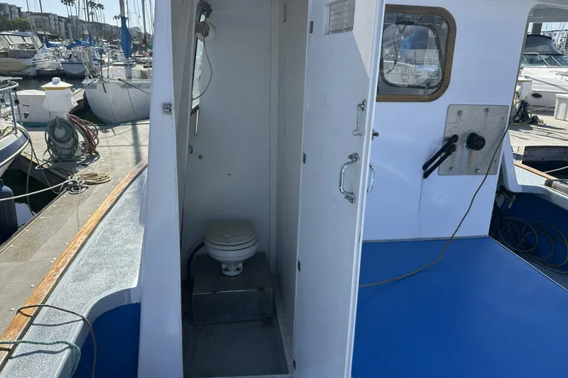 Slide: The Image of 1990 Seeway 31 boat with open cabin toilet, docked at marina. - 8