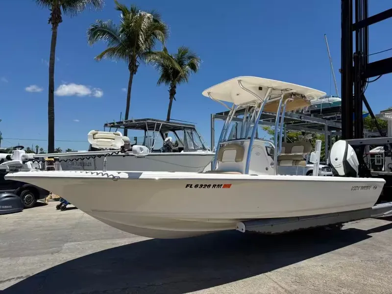Slide: The Image of 2018 Key West 230 Bay Reef boat docked with palm trees in background. - 6