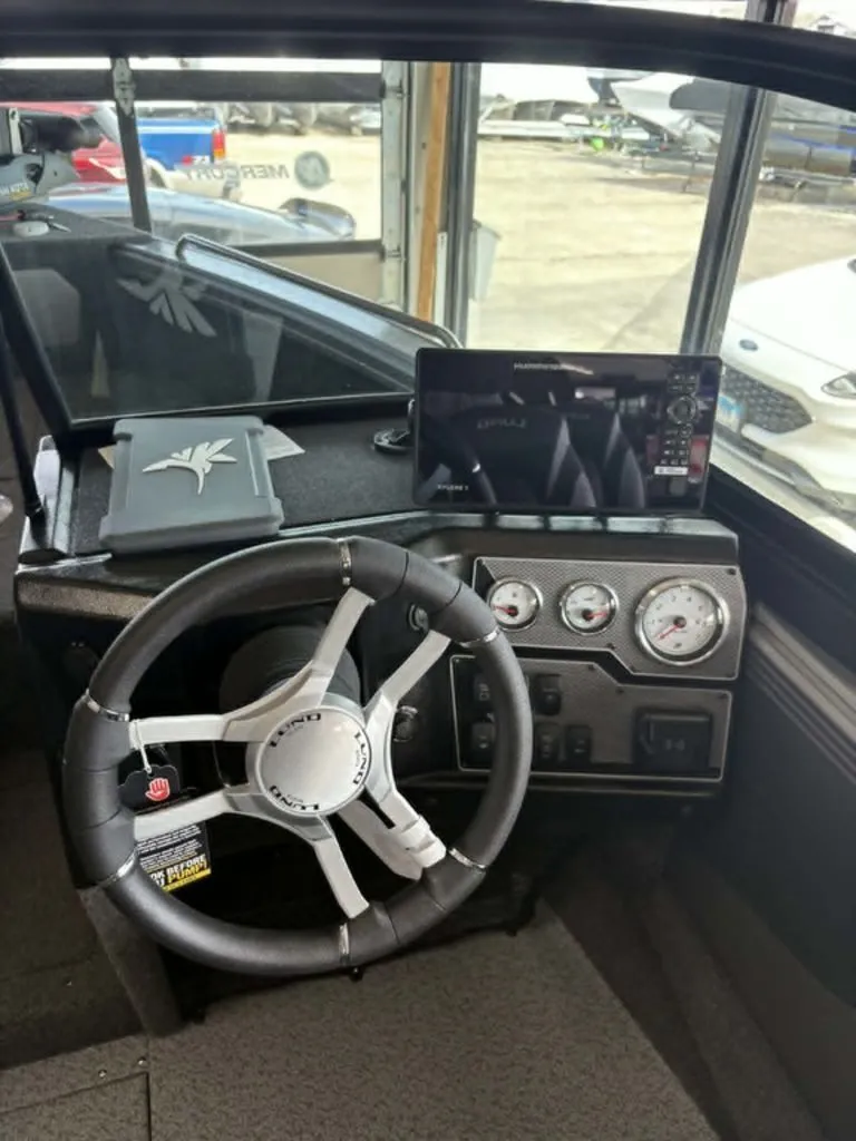 Slide: The Image of Interior view of 2026 Lund 1875 Tyee Sport boat with steering wheel and gauges. - 9