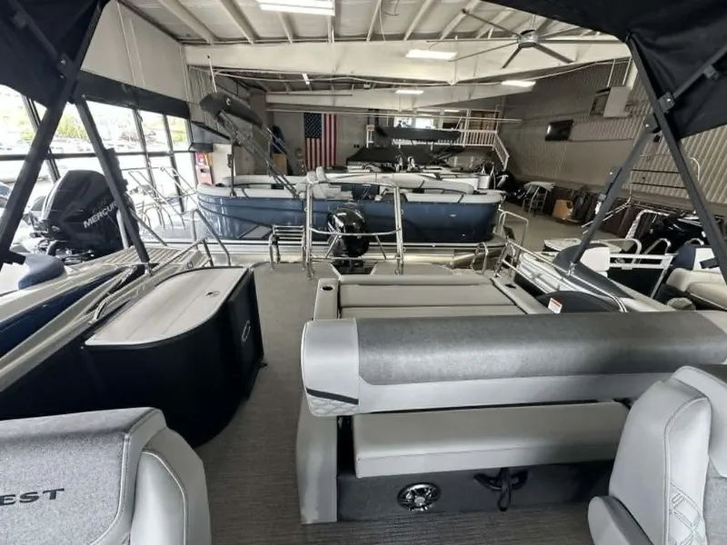 Slide: The Image of Interior view of a 2026 Crest Conquest 23 FT pontoon boat in showroom. - 13