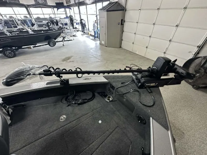 Slide: The Image of Lund 2075 Pro-V Sport 2026 with Minn Kota trolling motor in a boat workshop. - 4