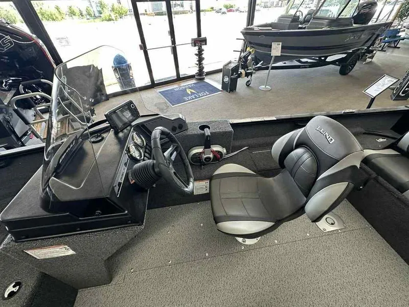 Slide: The Image of Interior view of Lund 1650 Rebel XL SS 2026 boat in showroom. - 6