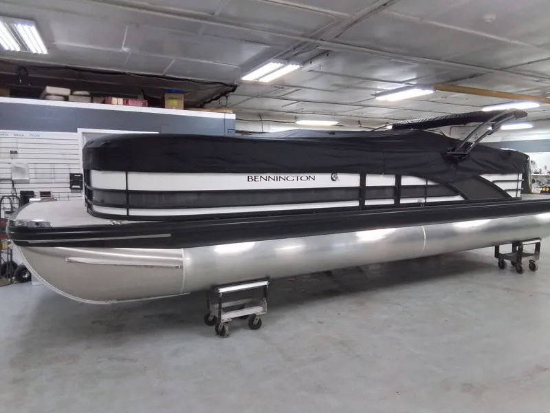 Slide: The Image of 2026 Bennington 25RSRSF pontoon boat in storage facility. - 25