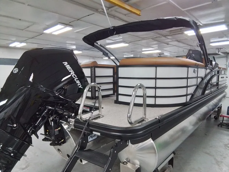 Slide: The Image of Bennington 25RSRSF 2026 pontoon boat with Mercury engine in workshop. - 6