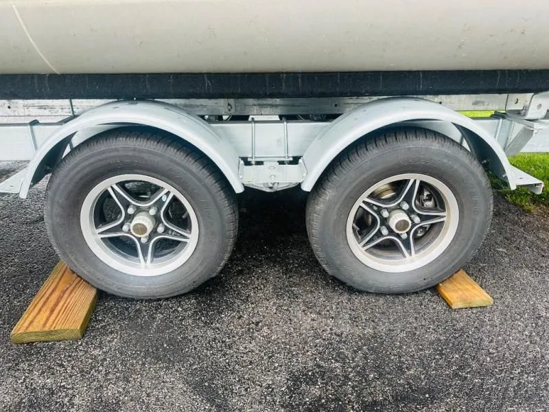 Slide: The Image of 2024 Godfrey Pontoons 2286 SB trailer wheels on wooden blocks. - 3