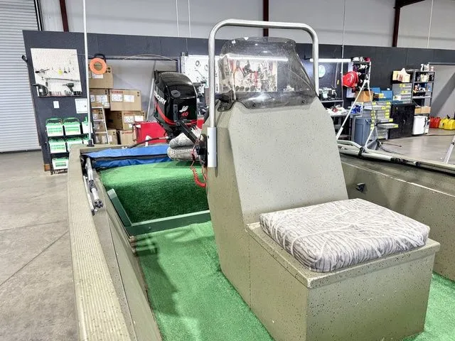 Slide: The Image of 2006 Tracker 1654CC boat in warehouse with green carpet. - 13