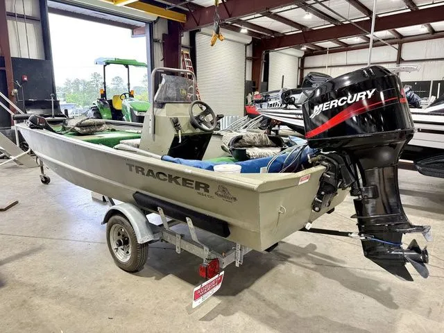 Slide: The Image of 2006 Tracker 1654CC boat with Mercury engine in warehouse. - 3