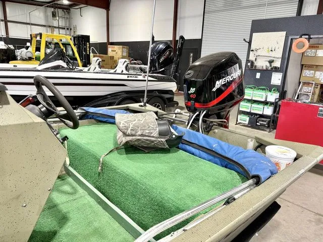 Slide: The Image of 2006 Tracker 1654CC boat with Mercury engine in workshop. - 8