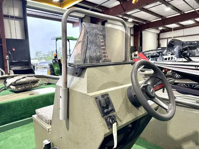 Slide: The Image of Interior view of a 2006 Tracker 1654CC boat in a warehouse. - 9