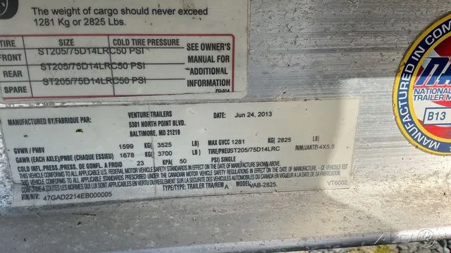 Slide: The Image of Trailer label with technical details and tire pressure information. - 14