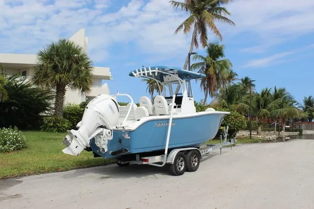 Slide: The Image of 2026 Sea Pro 245 FLXR Sandbar boat on trailer, palm trees in background. - 5