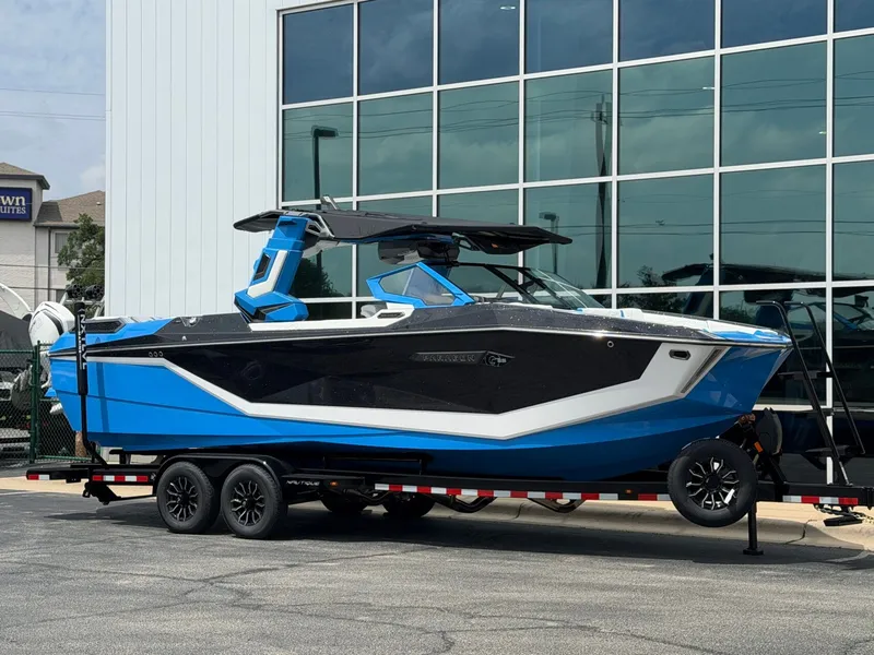 The Image of 2026 Nautique Super Air Nautique G25 Paragon on trailer outside building. - 1