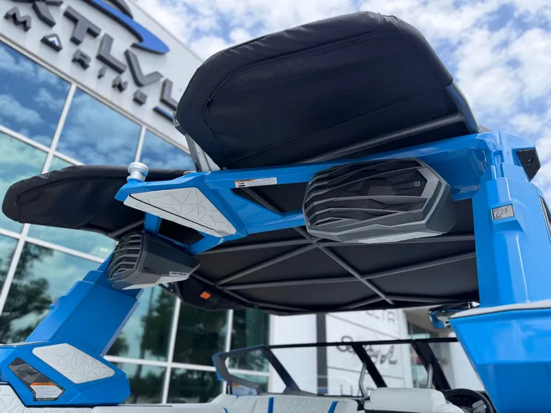 Slide: The Image of 2026 Nautique Super Air G25 Paragon with blue finish and speakers. - 10